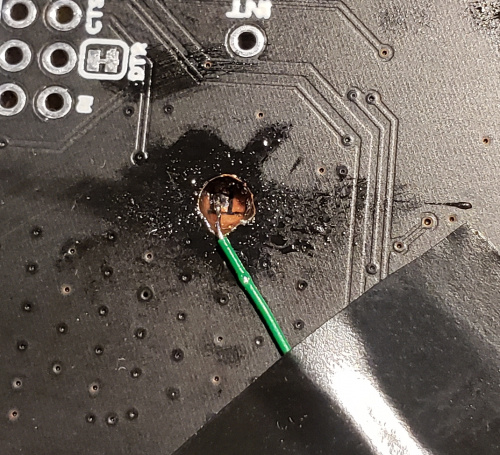 Wire soldered through hole onto pad